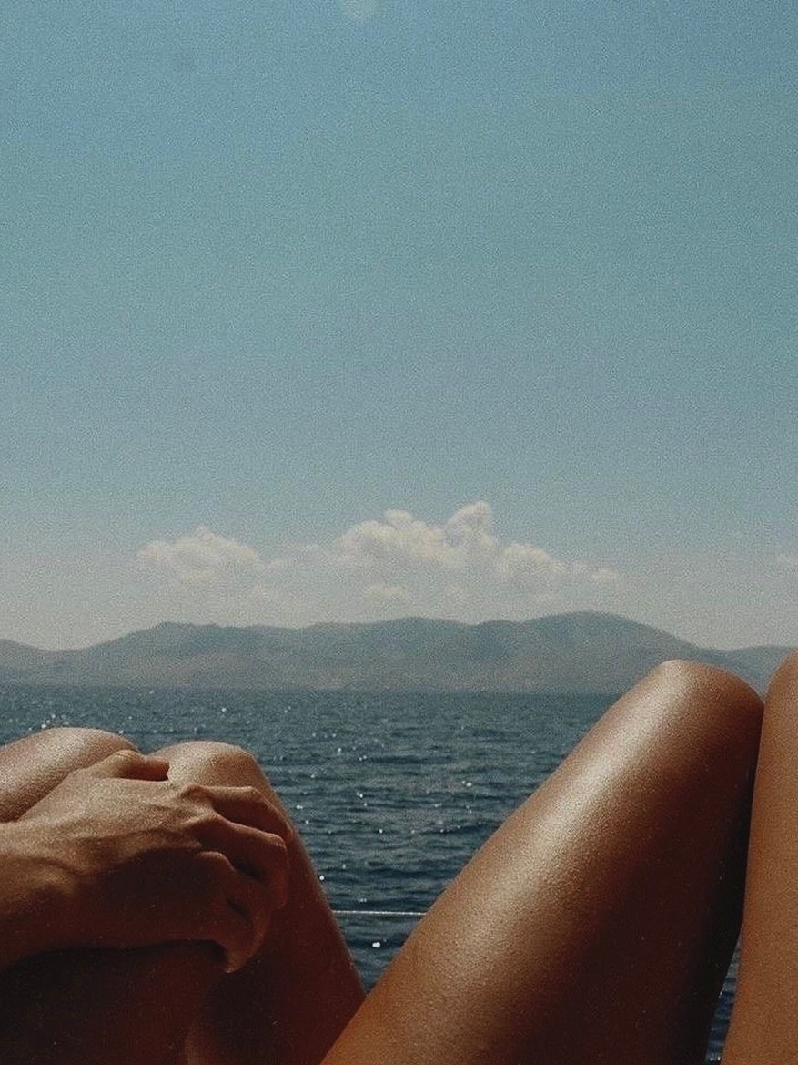 Two people holding hands illustrating the science of coregulation and how human touch heals the nervous system through polyvagal theory. beach