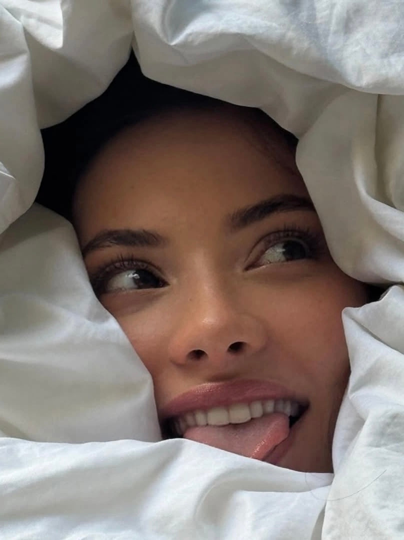 Woman sleeping peacefully in soft light representing the science of beauty sleep including collagen production skin barrier repair growth hormone and overnight skin renewal.