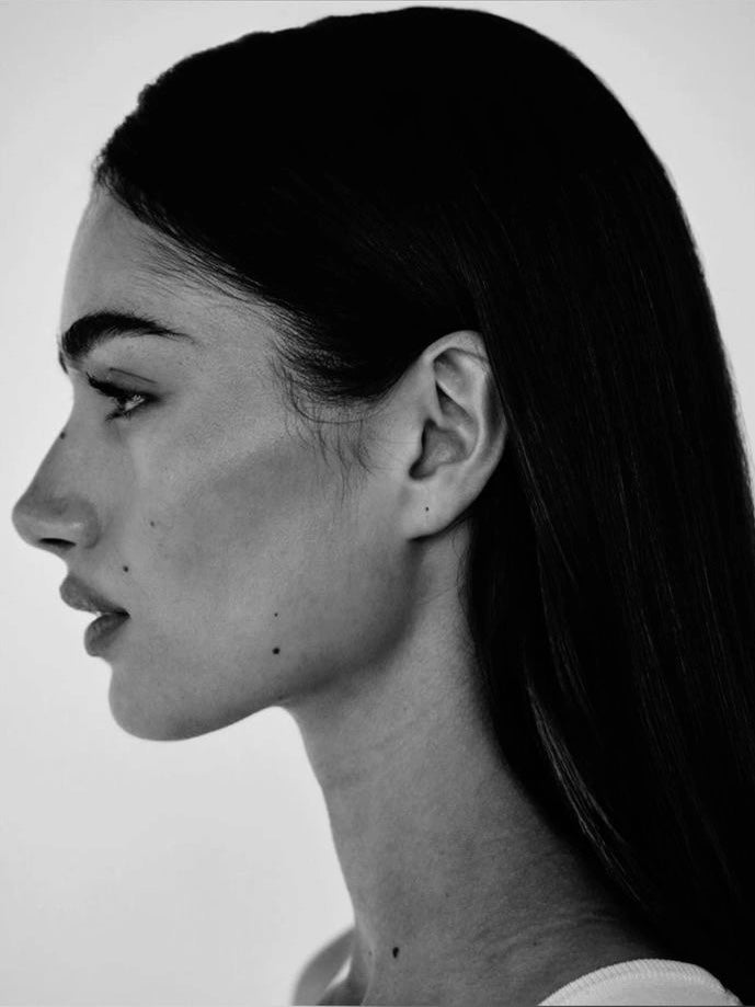 Close up of a woman's glowing healthy skin representing the science-backed connection between facial appearance and internal health markers including gut health sleep and hormones.